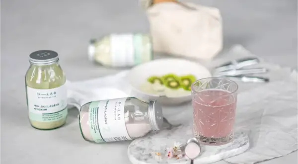 Verre de boisson rose et poudre de collagène pour une routine beauté. Le plaisir de boire du collagène.