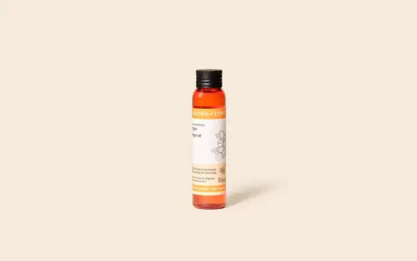 Flacon d'huile d'argan Aroma-Zone. Bien que rare, des effets secondaires comme des réactions allergiques peuvent survenir.